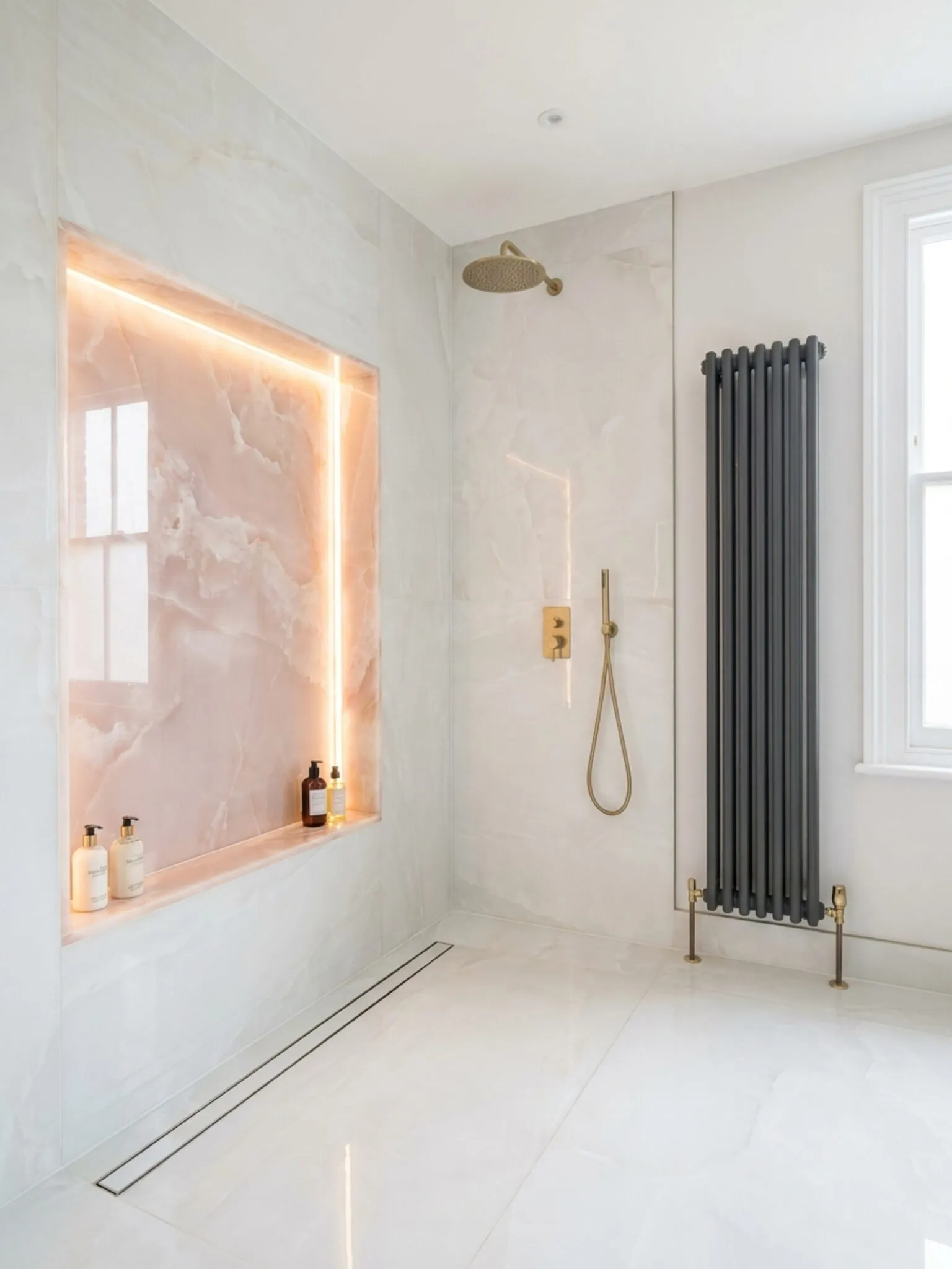 Walk-in shower with blush onyx niche and anthracite radiator