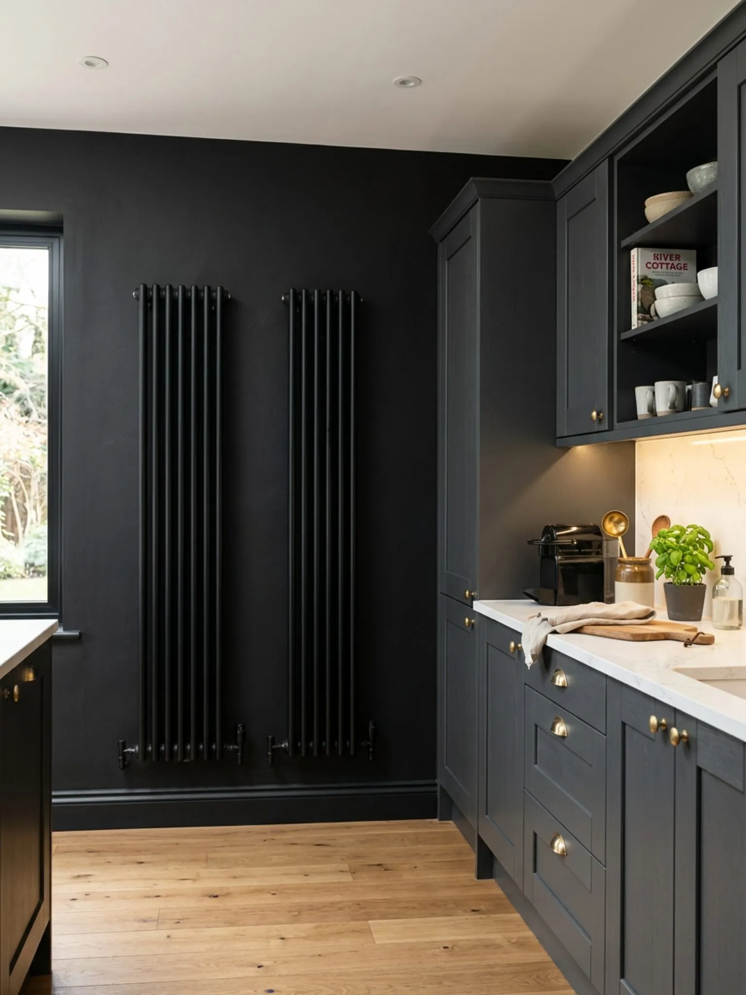 Black feature wall with vertical radiator and lit splashback