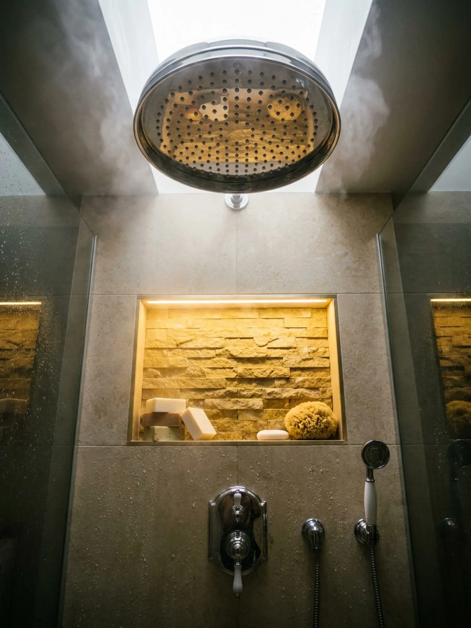 Looking up at the rainhead, lit niche and thermostatic valve