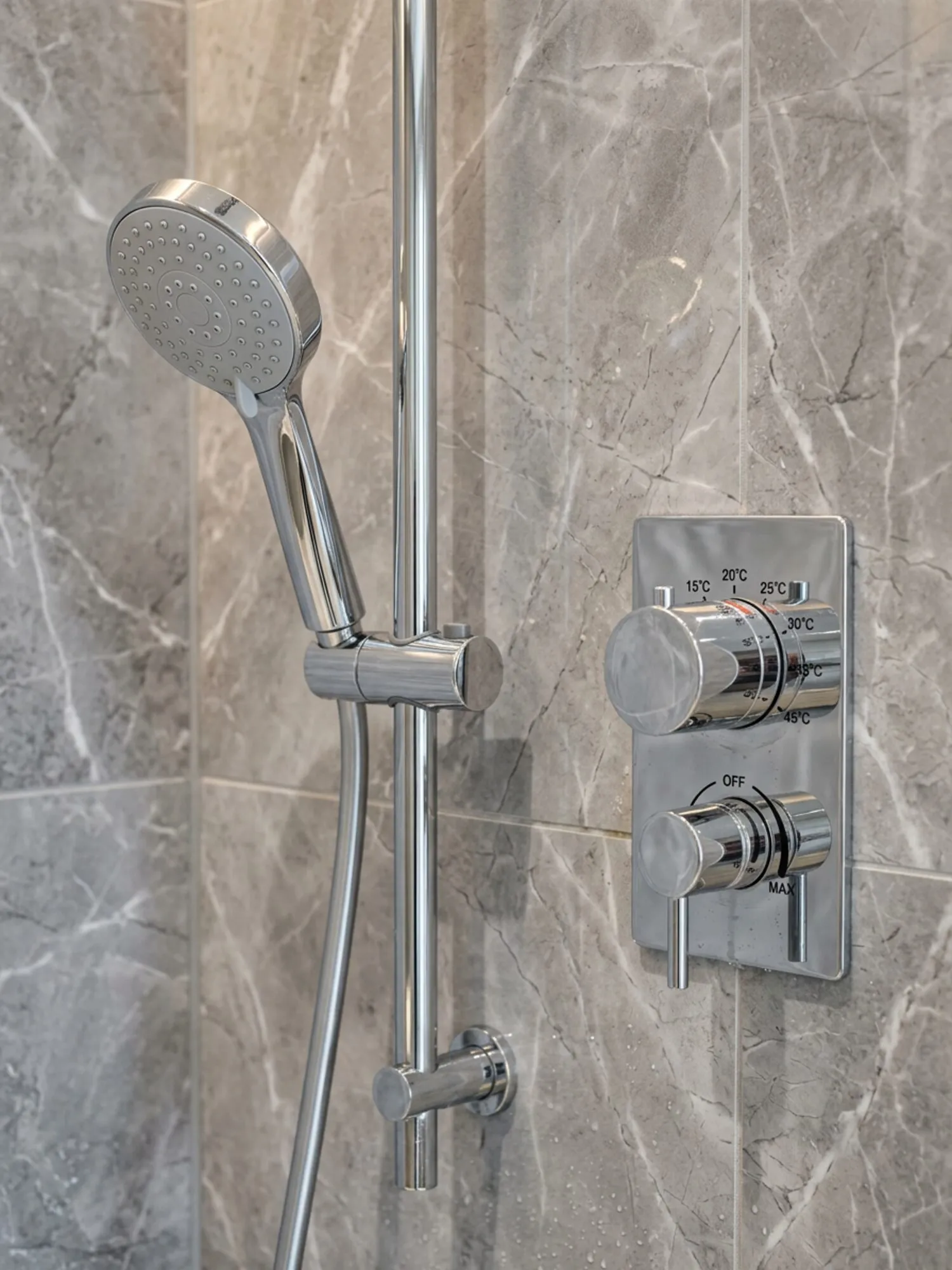 Chrome handset and thermostatic control detail
