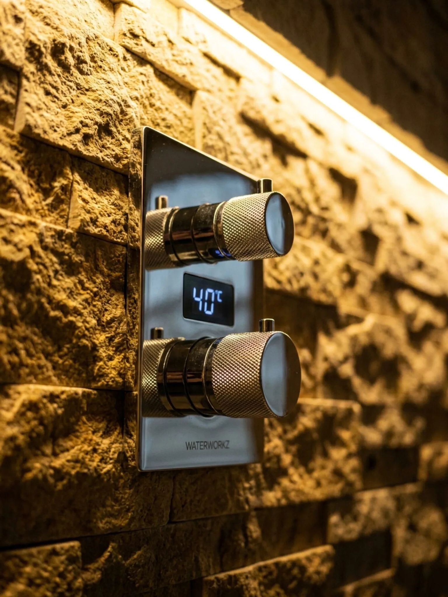 Thermostatic valve set against split-face ledgestone